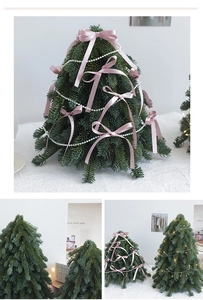Detailed view of mini Christmas tree with pink silk bows and white pearl ornaments