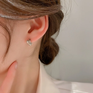 Minimalist silver twist hoop earrings for women with high-shine metallic mirror finish