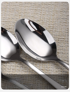 Macro shot of polished stainless steel spoon head with smooth rounded edges and mirror finish