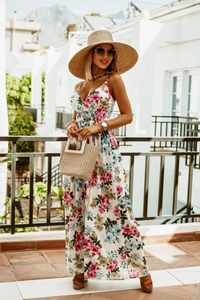 Detail of bohemian floral maxi dress with thin straps and airy white fabric material