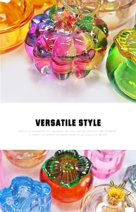 Detail of colorful pumpkin-shaped glass containers with decorative metallic lids