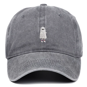 Close-up of ghost embroidery detail on a washed dark gray cotton baseball cap