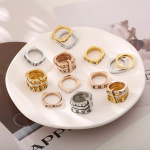 Dettaglio di anelli quadrati con numeri romani e diamanti in oro argento e oro rosa