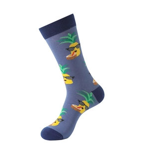 Close-up of cotton crew socks with cartoon pineapple patterns and blue contrast stitching