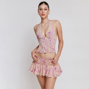 Detail of floral halter neck top and ruffled mini skirt set with buttons and elastic waist