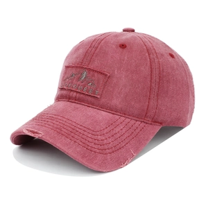 Detail of washed cotton baseball cap featuring vintage frayed brim and mountain patch