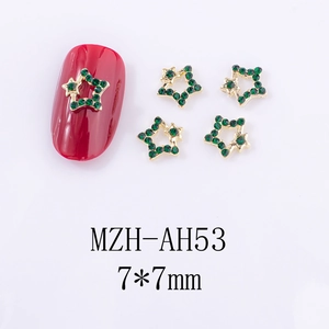 Détail de bijoux d'ongles étoiles dorées de 7x7mm avec strass verts pour manucure