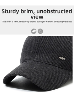 Close-up of textured dark grey baseball cap with silver metal Z logo detail and curved brim