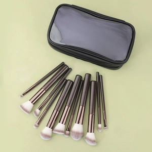 Detailed set of 11 professional makeup brushes with wood handles and a black zipper pouch