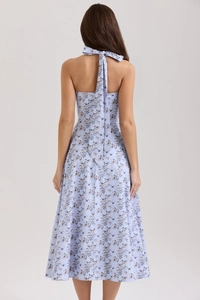 Detail view of light blue floral halter maxi dress with backless design and neck tie bow