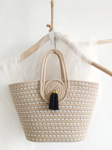 Large capacity striped woven straw cotton rope tote bag with black tassel on white hanger