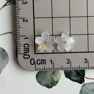 Close-up of translucent white resin flower beads with 1.4cm diameter measurement