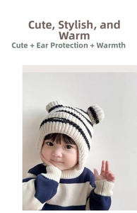 Close-up of knit baby earflap hat with black stripes and cute 3D bear ears for winter