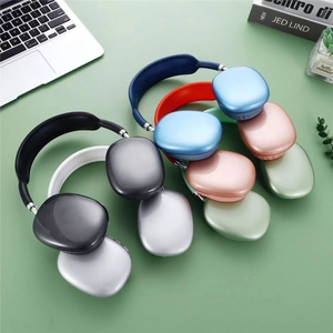 Overhead view of P9 wireless headphones in multiple colors on a green desk with laptop