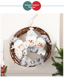 Close-up of a Christmas rattan wreath featuring plush Santa Claus and snowman dolls