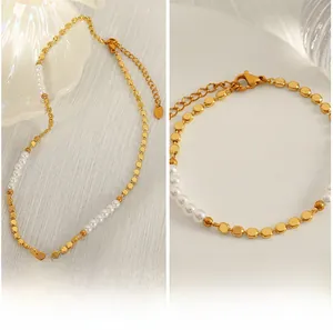 Close-up of gold square beads and white pearls with lobster clasp and extension chain