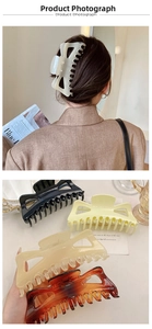 Detail of 14cm French style oversized hair claw clips in assorted glossy colors on a model