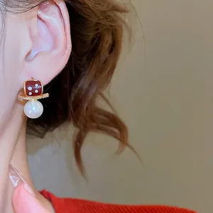 18K gold plated red enamel dice earrings with pearls and crystals on female model