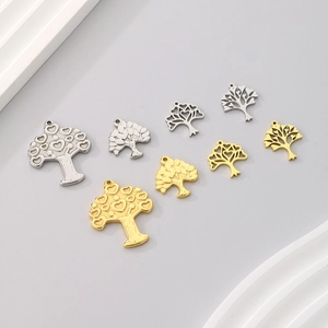 Detail view of heart-shaped tree of life pendants in gold and silver finishes
