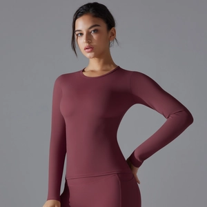 Detail view of burgundy long sleeve yoga top with high waist leggings set in studio