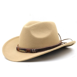 Detail of khaki cowboy hat with ethnic braided band and a vintage metal feather charm