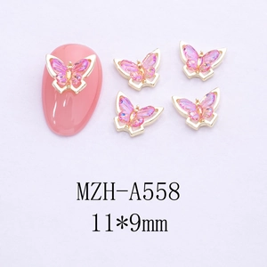 Detail showing 11x9mm pink 3D butterfly nail art charms with gold metal frame