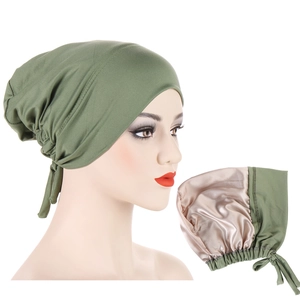 Detail view of army green turban hat showing light gold satin lining for hair protection