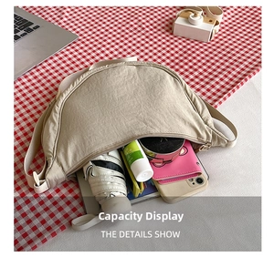 Detailed interior view of a beige nylon crossbody bag showing large storage capacity