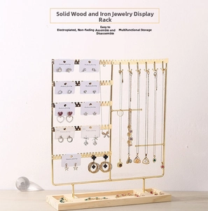 Detail view of gold jewelry display stand with solid wood base and multi-layer hooks