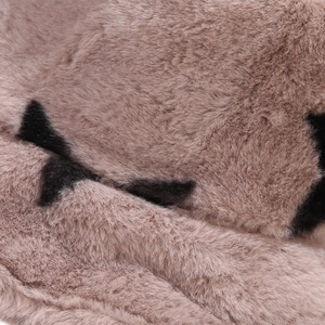 Macro detail of soft faux fur texture featuring pink and black spotted star pattern