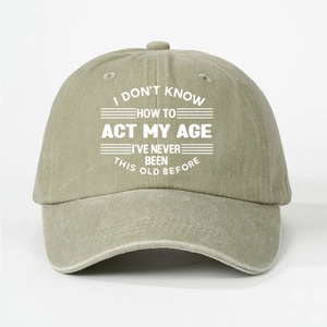 Detail of khaki washed cotton baseball cap with printed humorous white slogan on front
