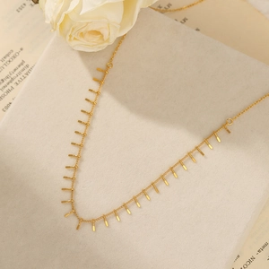 Minimalist 18K gold plated stainless steel necklace with rectangular charms on a gift box