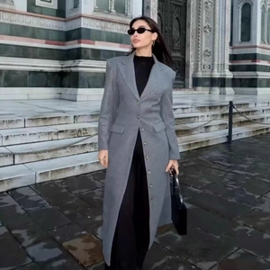 Elegant long grey slim-fit wool coat featuring a notched lapel and button closure style