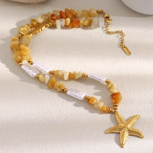 Detailed macro view of 18K gold plated starfish pendant with natural stone beads