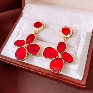 Vintage gold and red enamel flower drop earrings in a luxury jewelry gift box