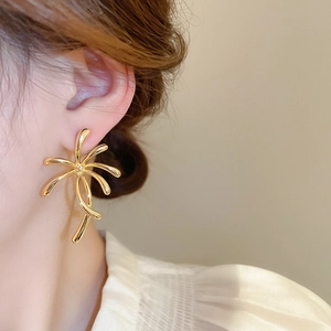 Detailed view of a gold-plated flower stud earring featuring radiant starburst design