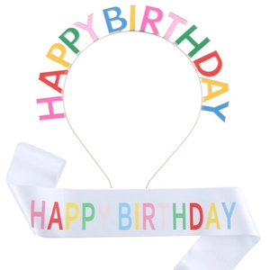 Detail of happy birthday headband and white satin sash set with colorful lettering