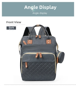 Front view of grey diaper backpack with quilted pocket and brown leather pullers