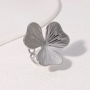 Detailed close-up of a silver petal ring with radial textures and adjustable open band