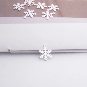 Close-up of small silver snowflake pendant for DIY jewelry making and bracelet charms