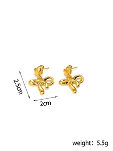 Detail of gold heart bow earrings, measuring 2.5cm by 2cm and weighing 5.5g