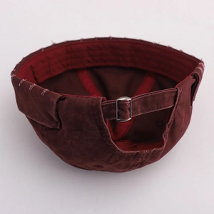 Detail of vintage washed docker hat with metal adjustable buckle and distressed frayed edges