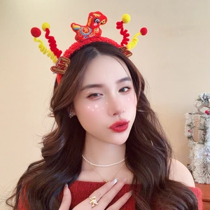 Detail of red festive headband featuring plush horse mascot and spring ball decorations