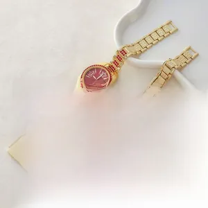 Detail of luxury gold chain watches with colorful crystals and Roman numeral dials