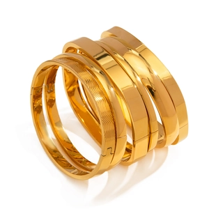 5-piece gold stainless steel bangle set featuring polished finish and wave texture