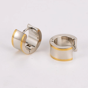 Close-up of wide stainless steel hoop earrings with gold edges and secure snap closure