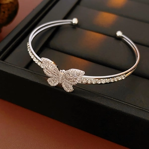 Macro shot of silver butterfly open cuff bangle with sparkling cubic zirconia on display