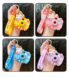 Detail view of cute rabbit projection camera keychains in four different vibrant colors