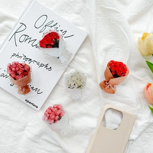 Collage of floral acrylic phone socket grips featuring roses and daisies in chic packaging