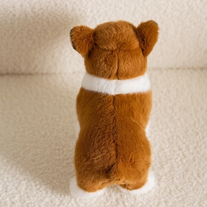 Rear view of a cute plush Corgi dog toy showing a fluffy round bottom and soft brown fur